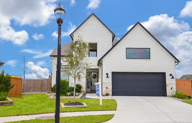 view of front of house with a garage and a front lawn