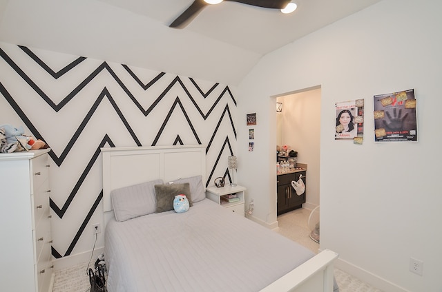 carpeted bedroom featuring connected bathroom, ceiling fan, and lofted ceiling