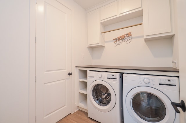 laundry room featuring cabinets, separate washer and dryer, and light hardwood / wood-style flooring