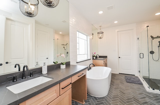 bathroom featuring a chandelier, vanity, and independent shower and bath