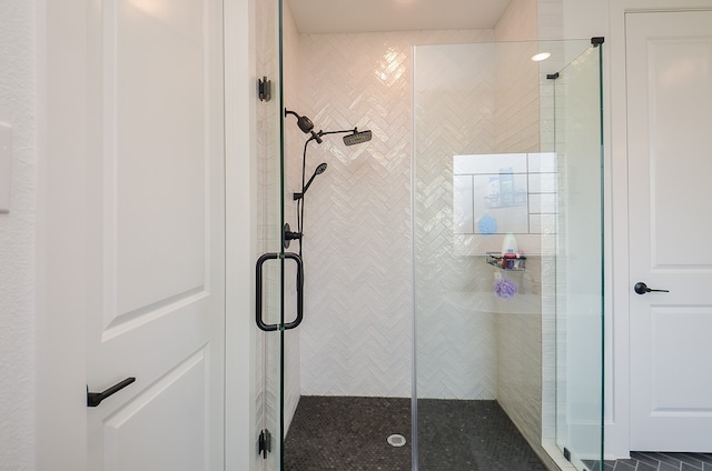 bathroom featuring a shower with shower door