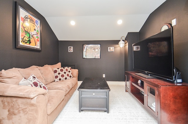 carpeted living room with lofted ceiling