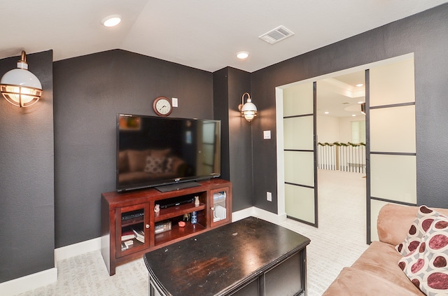 carpeted living room with vaulted ceiling