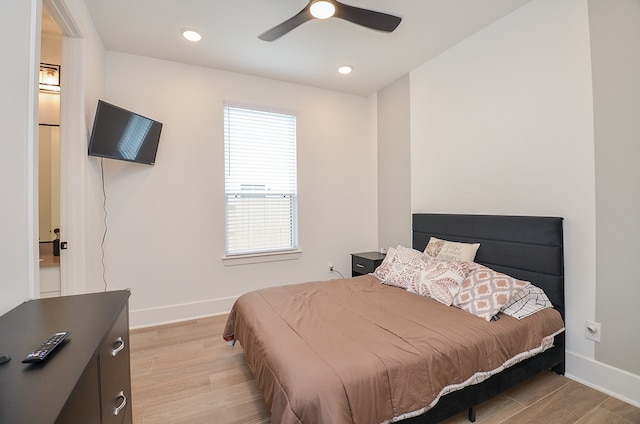 bedroom with light hardwood / wood-style flooring and ceiling fan