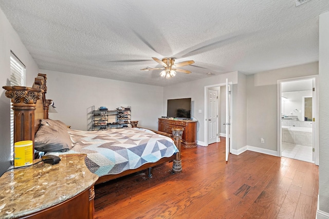 bedroom with a textured ceiling, dark hardwood / wood-style flooring, ensuite bath, and ceiling fan