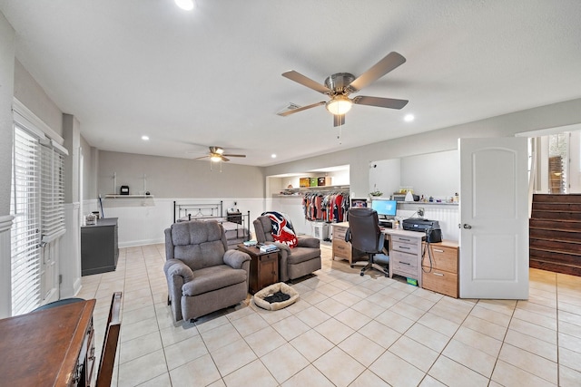 living room with ceiling fan and light tile patterned floors