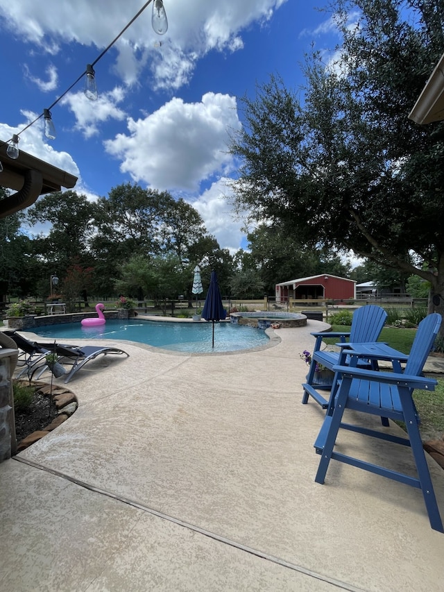 view of swimming pool with a patio area