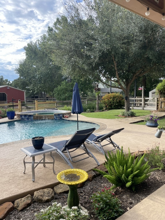 view of swimming pool with an in ground hot tub and a patio