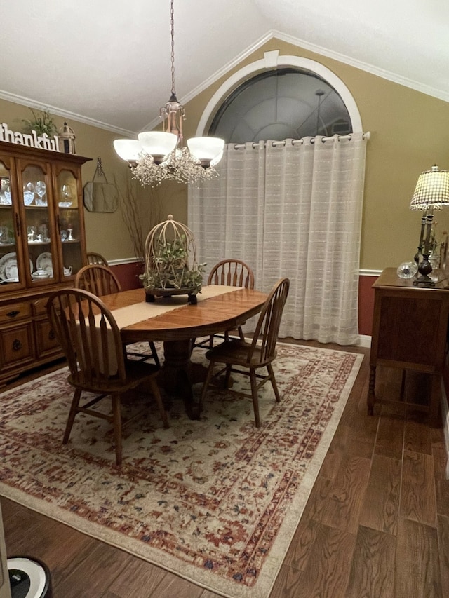 dining space featuring crown molding, dark hardwood / wood-style flooring, a chandelier, and lofted ceiling