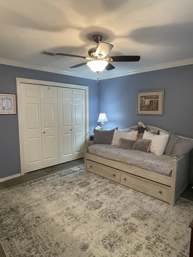 bedroom with a closet, ceiling fan, and ornamental molding