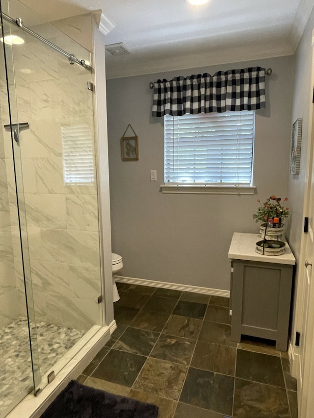 bathroom with a shower with shower door, toilet, and ornamental molding