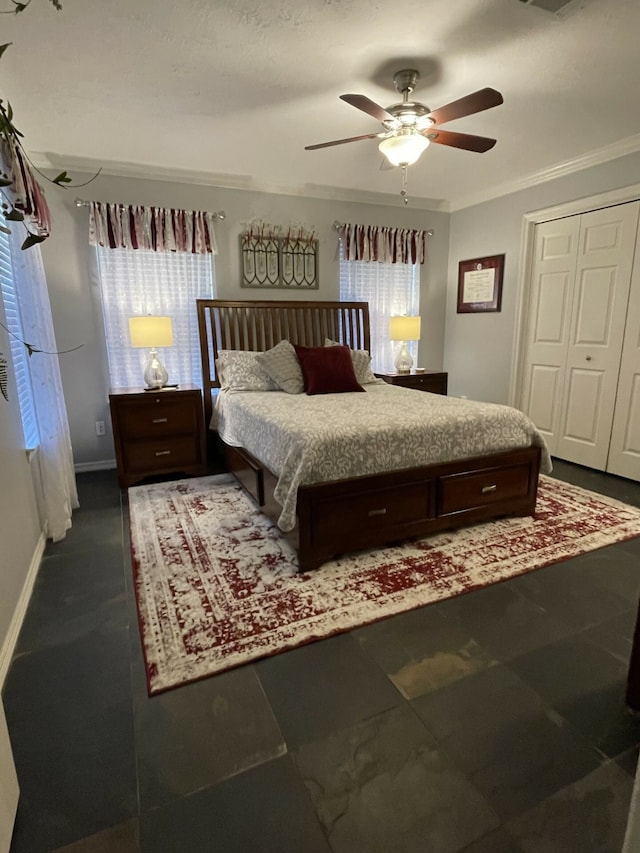 bedroom featuring multiple windows, ceiling fan, a closet, and ornamental molding