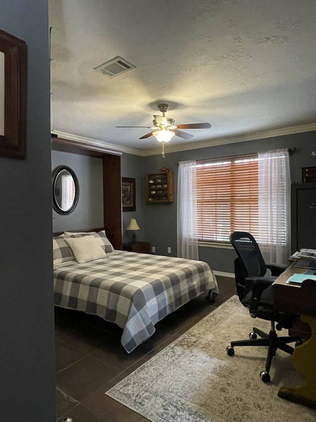 tiled bedroom with ceiling fan, crown molding, and a textured ceiling