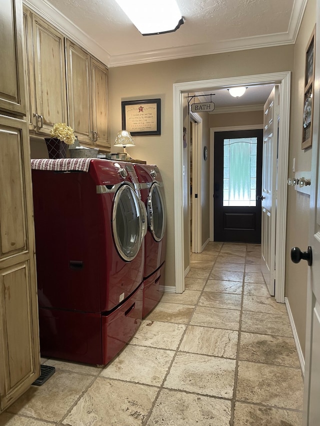 laundry area with ornamental molding, cabinets, and independent washer and dryer