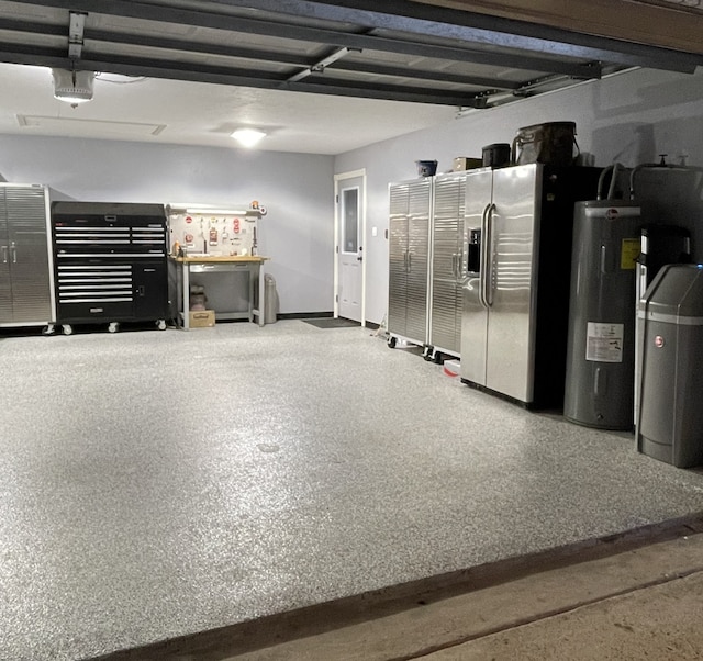 garage with stainless steel fridge and water heater