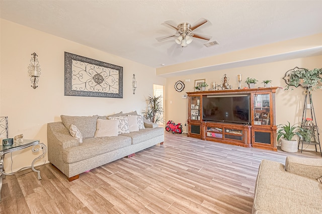 living room featuring ceiling fan and hardwood / wood-style floors