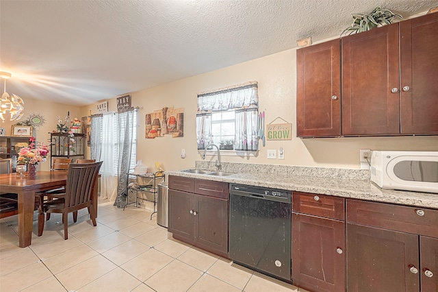 kitchen featuring a textured ceiling, light tile patterned flooring, sink, and black dishwasher