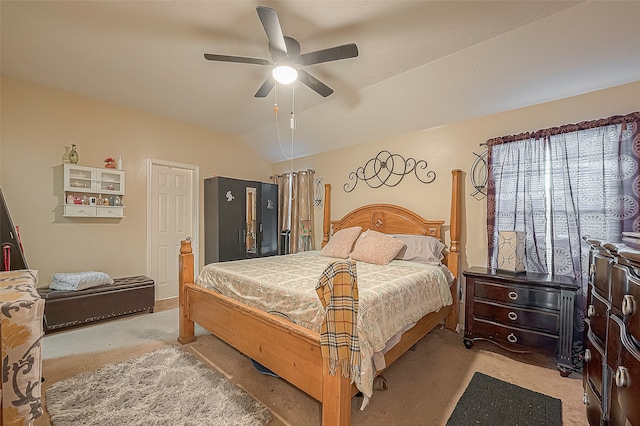 carpeted bedroom featuring vaulted ceiling and ceiling fan