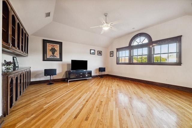 unfurnished living room featuring ceiling fan, light hardwood / wood-style floors, and vaulted ceiling