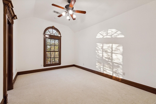 carpeted spare room with ceiling fan and lofted ceiling