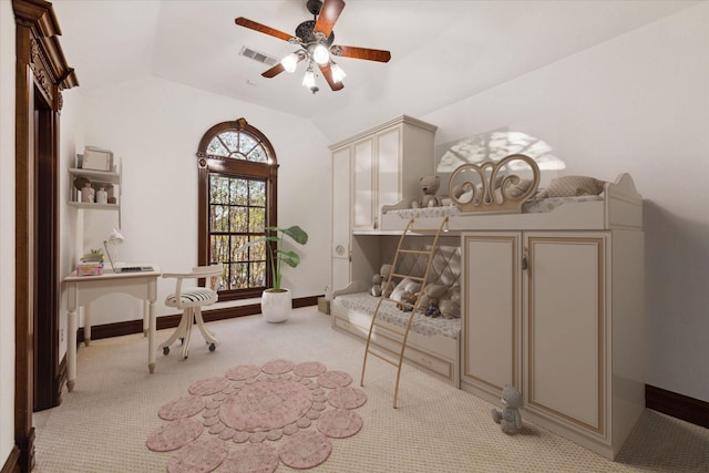 interior space with light carpet, ceiling fan, and vaulted ceiling