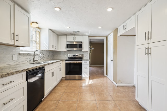 kitchen featuring stainless steel appliances, sink, and white cabinets