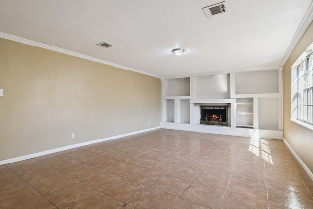 unfurnished living room with tile patterned flooring, built in shelves, and ornamental molding