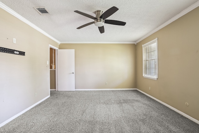 spare room featuring crown molding, carpet flooring, ceiling fan, and a textured ceiling