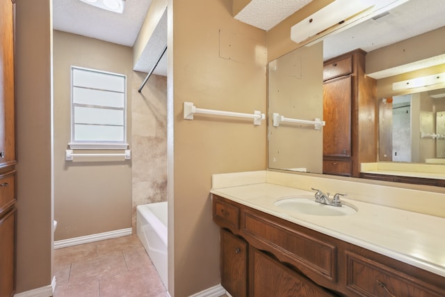 bathroom featuring vanity, tile patterned flooring, and a textured ceiling