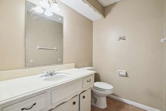 bathroom featuring vanity, tile patterned floors, and toilet