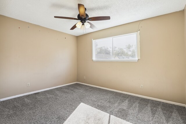 carpeted empty room featuring ceiling fan and a textured ceiling