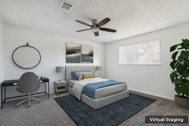 carpeted bedroom featuring ceiling fan and a textured ceiling