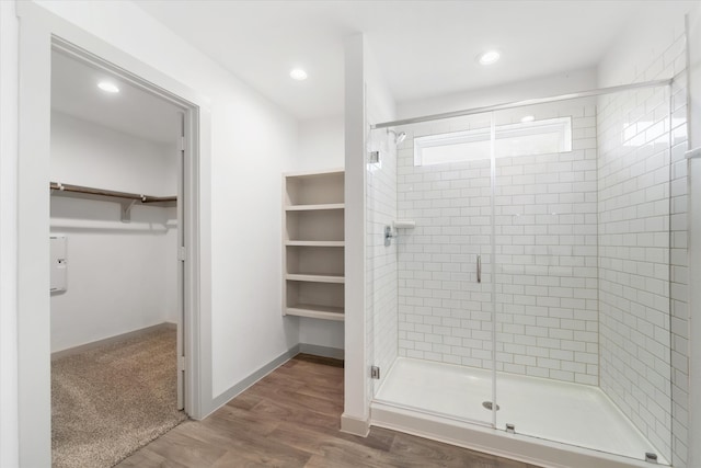 bathroom featuring an enclosed shower and wood-type flooring