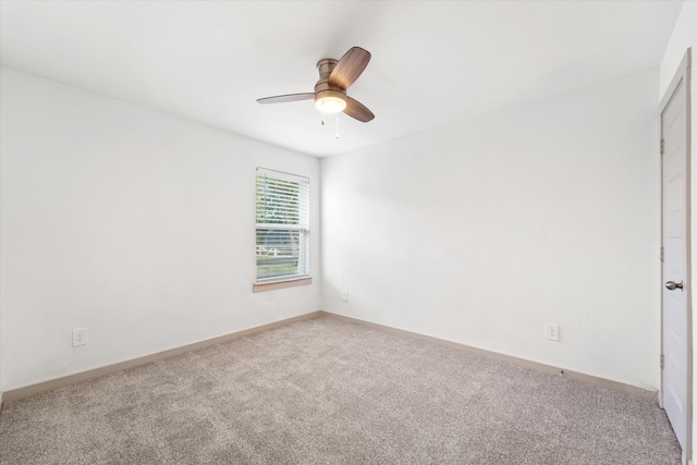 spare room with carpet flooring and ceiling fan