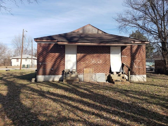 view of side of property with a yard