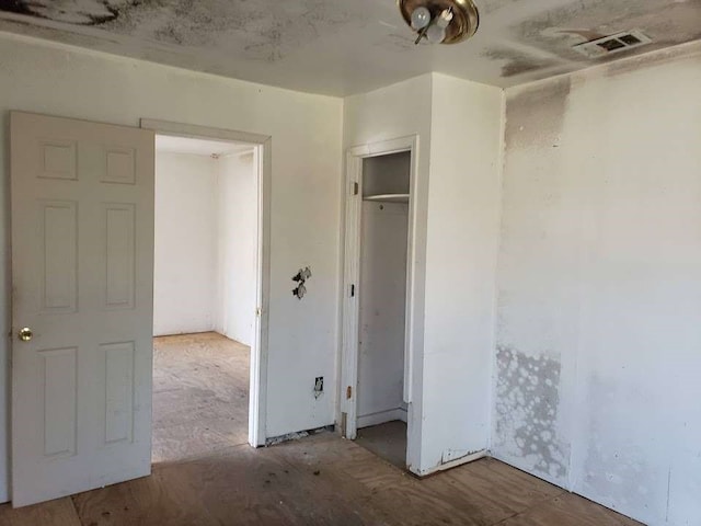 unfurnished bedroom with a closet