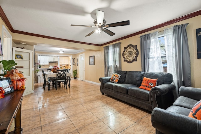 living room with ceiling fan, a textured ceiling, and ornamental molding