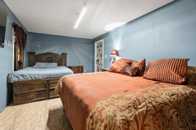 bedroom with light tile patterned floors