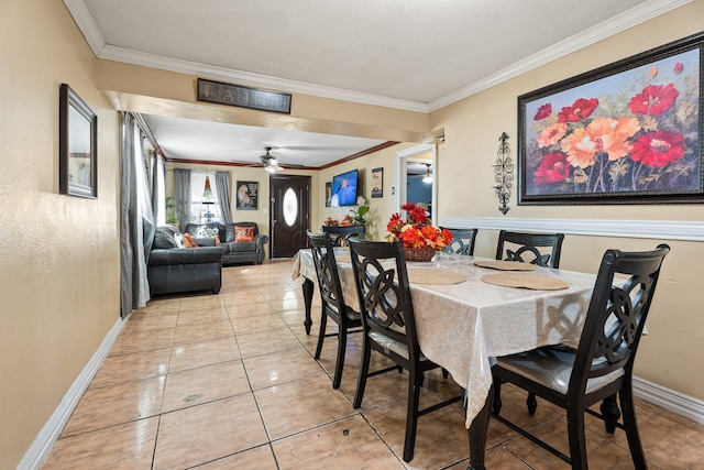 dining space with ceiling fan, ornamental molding, and light tile patterned flooring