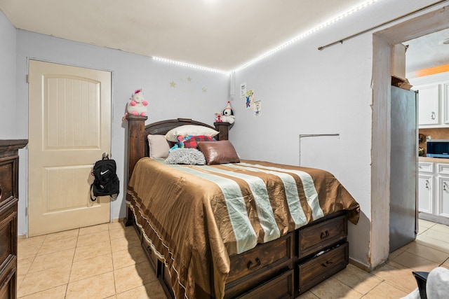 tiled bedroom with stainless steel fridge