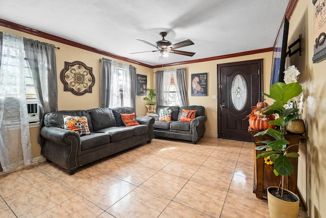 tiled living room with ceiling fan, a textured ceiling, and ornamental molding