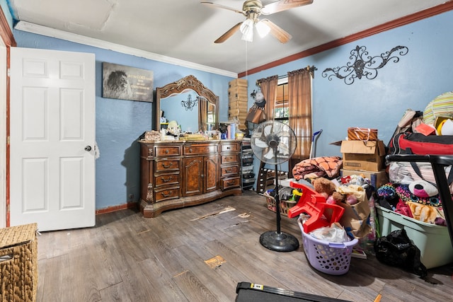 bedroom with hardwood / wood-style floors, ceiling fan, and ornamental molding