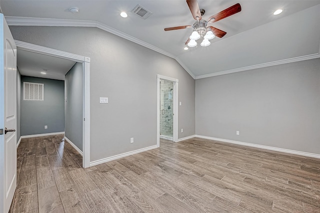 spare room featuring light hardwood / wood-style floors, vaulted ceiling, ceiling fan, and crown molding