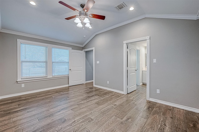 unfurnished bedroom with ceiling fan, lofted ceiling, ornamental molding, and light hardwood / wood-style flooring