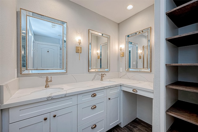 bathroom featuring hardwood / wood-style floors, vanity, and built in features