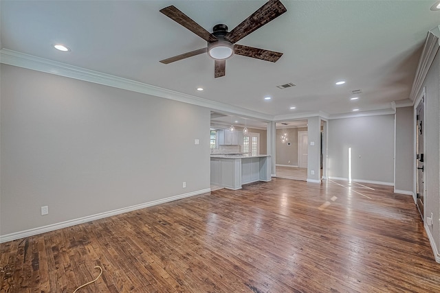 unfurnished living room with ceiling fan, wood-type flooring, and ornamental molding