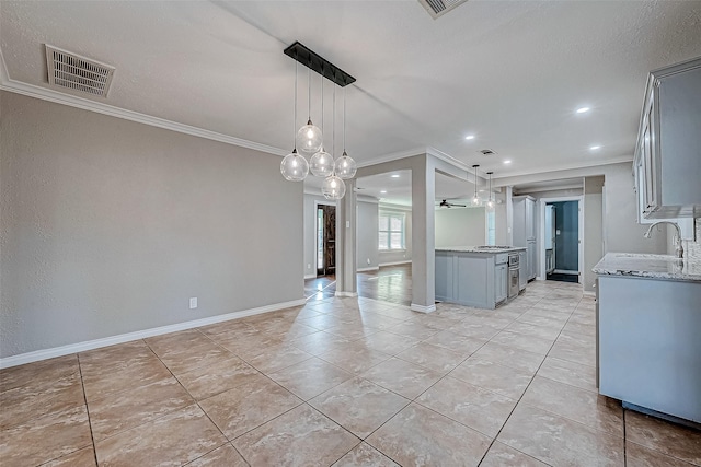 kitchen featuring ceiling fan, gray cabinets, crown molding, and hanging light fixtures