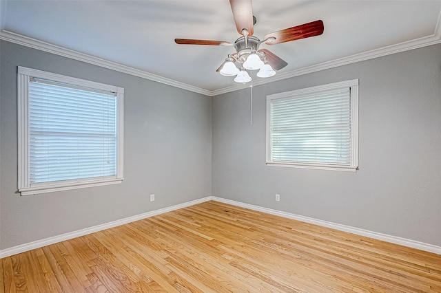 spare room featuring a wealth of natural light, light hardwood / wood-style flooring, and ornamental molding