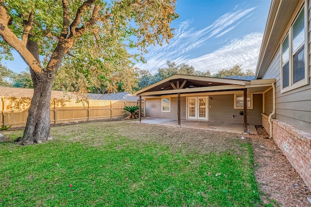 view of yard with french doors and a patio