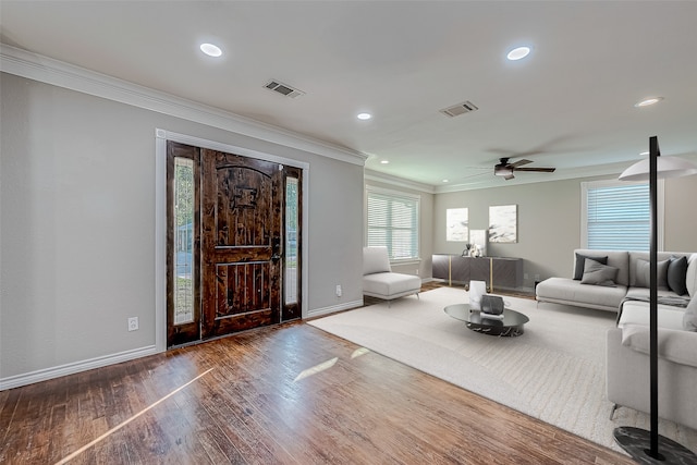 entryway featuring hardwood / wood-style flooring, ceiling fan, and crown molding